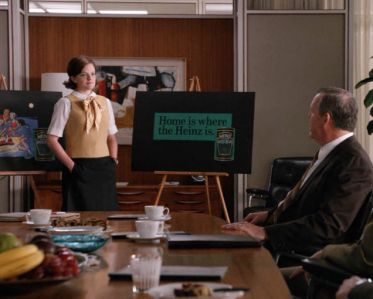 A still image from the TV show Mad Men, with Peggy, the copywriter, delivering a pitch