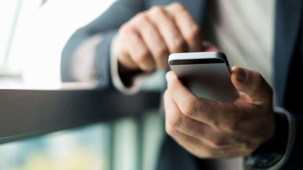 LinkedIn marketing represented by a man holding a mobile phone
