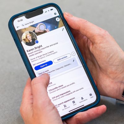 A close up of Karen's LinkedIn profile on her phone