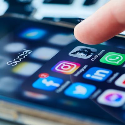 Close up of a phone with social media icons to represent a blog on LinkedIn trends for 2026